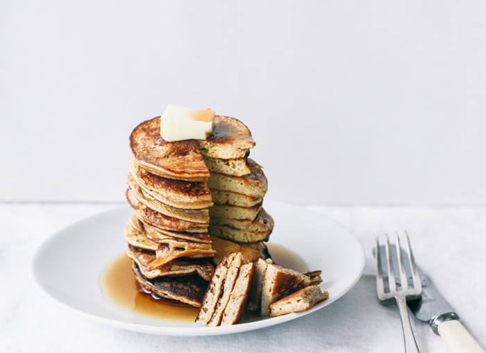 A stack of cut healthy pancakes with butter on top