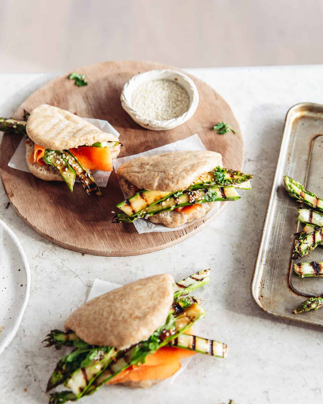 bao buns overhead filled with grilled asparagus and carrot ribbons