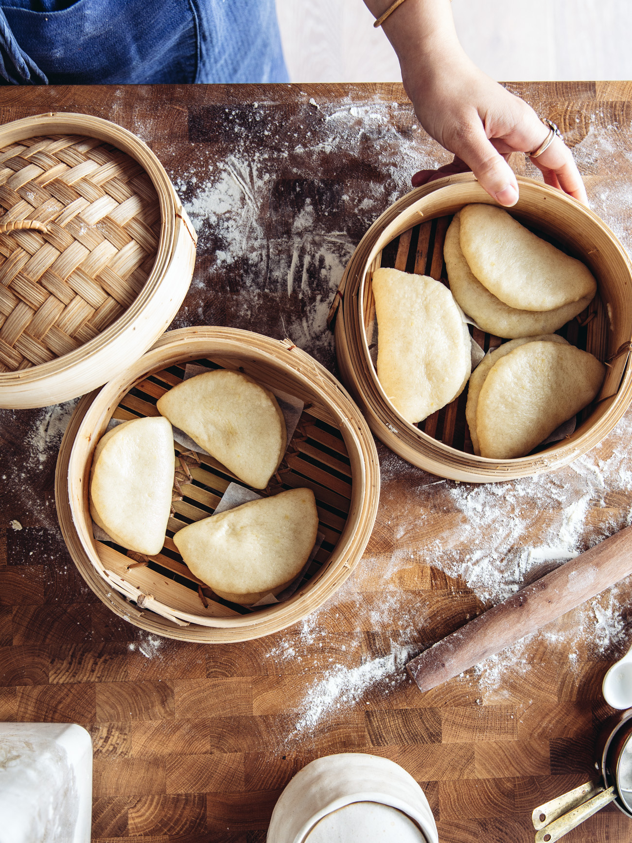 Steamed gua bao buns in a bamboo steamer