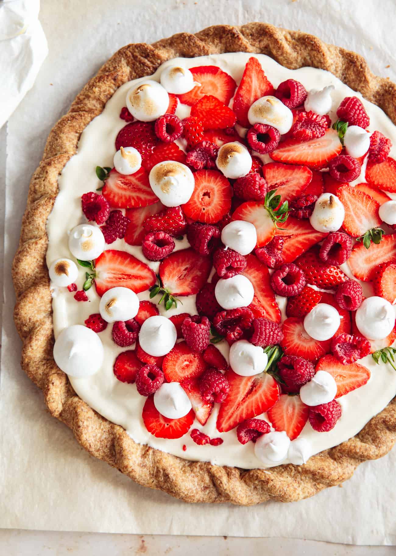 Eton mess tart with strawberries, raspberries and torched meringue