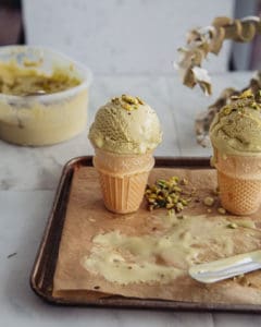 two ice cream cones with pistachio ice cream