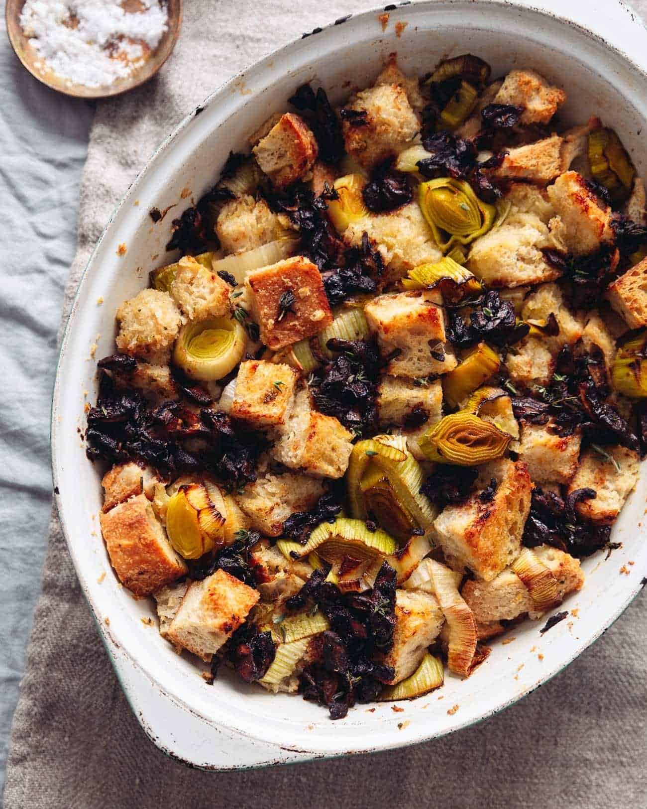 A close up of a dish of vegan sourdough stuffing with leeks and soy-sauce mushrooms