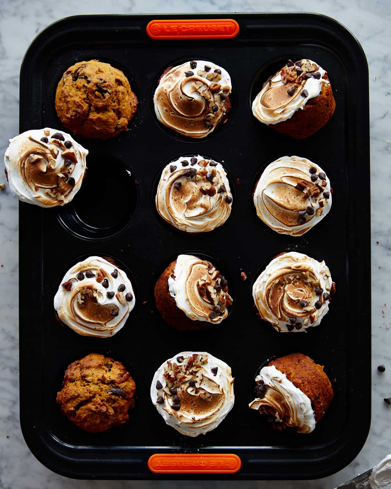 Sweet potato cupcakes with meringue frosting in a muffin tin