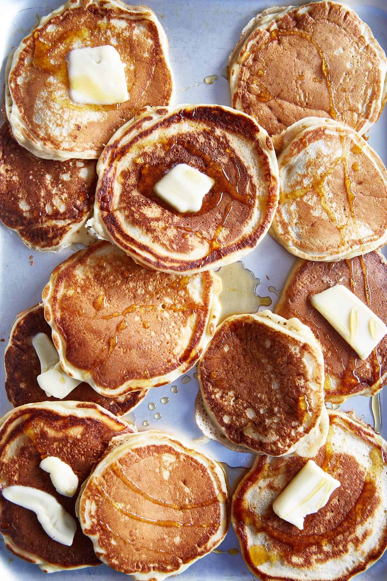 a tray of American style buttermilk pancakes with butter  & maple syrup