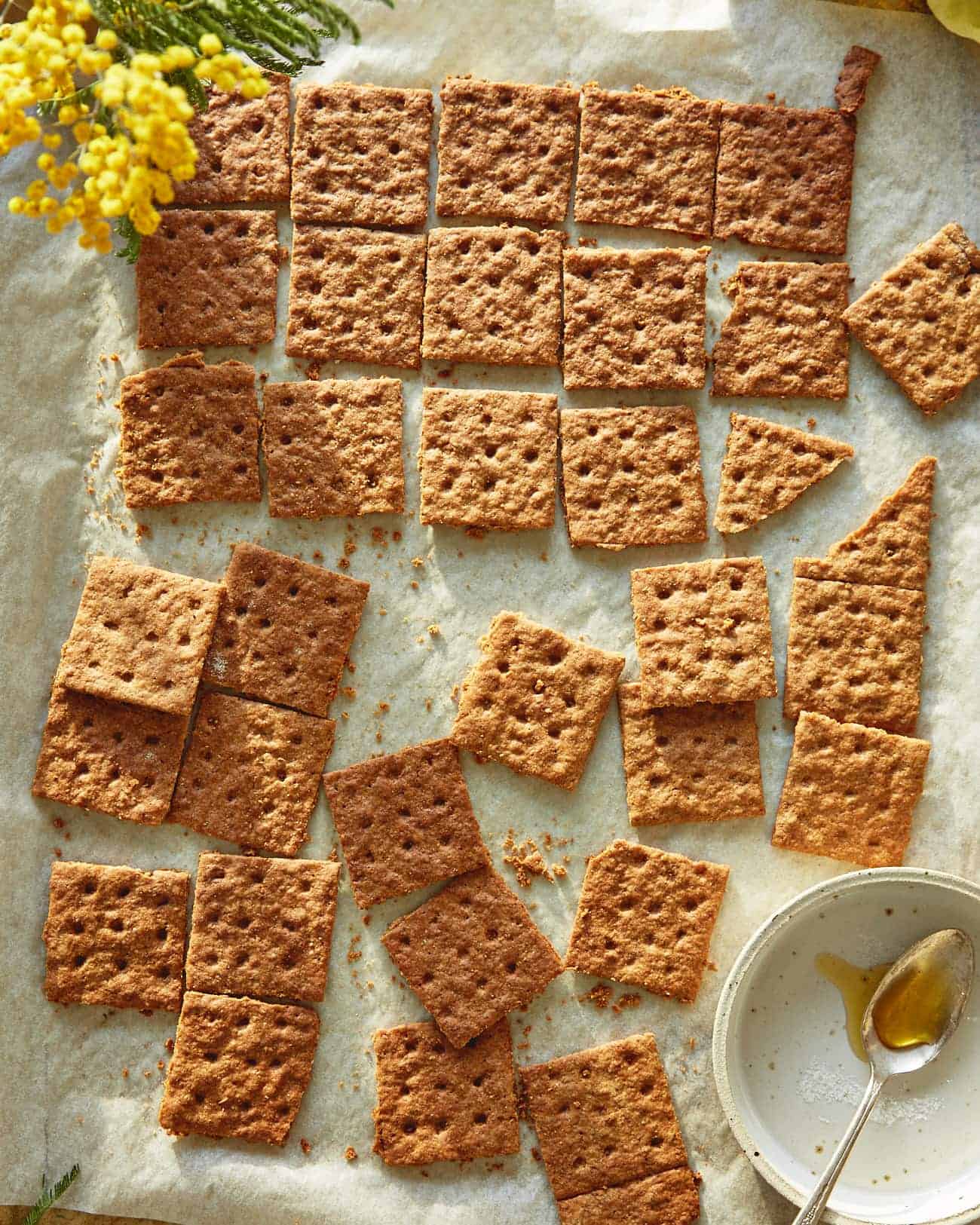 homemade graham crackers separated on a baking sheet