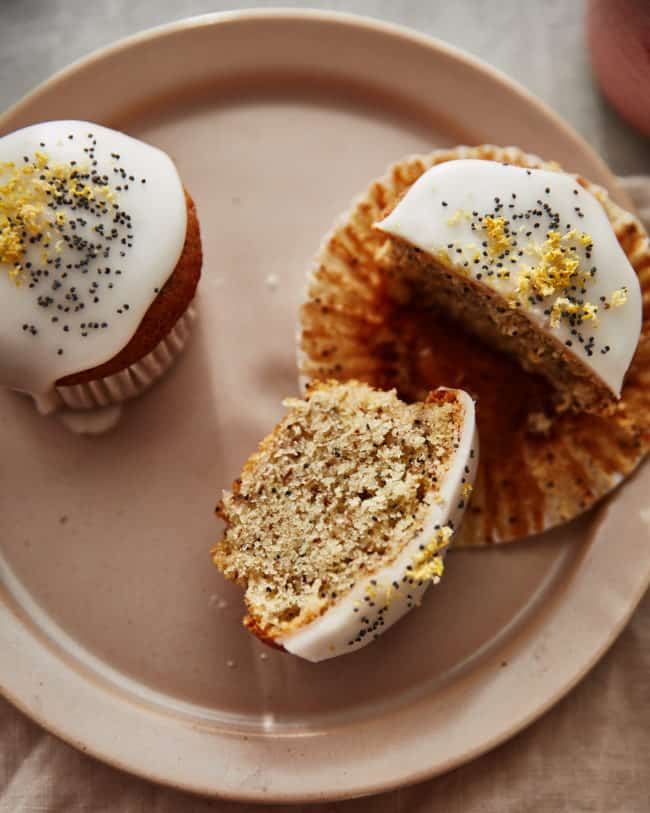 a vegan cut lemon poppyseed muffin on a plate