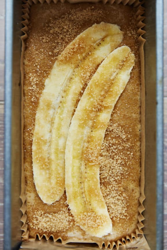 unbaked sourdough banana bread batter topped with slices of fresh banana