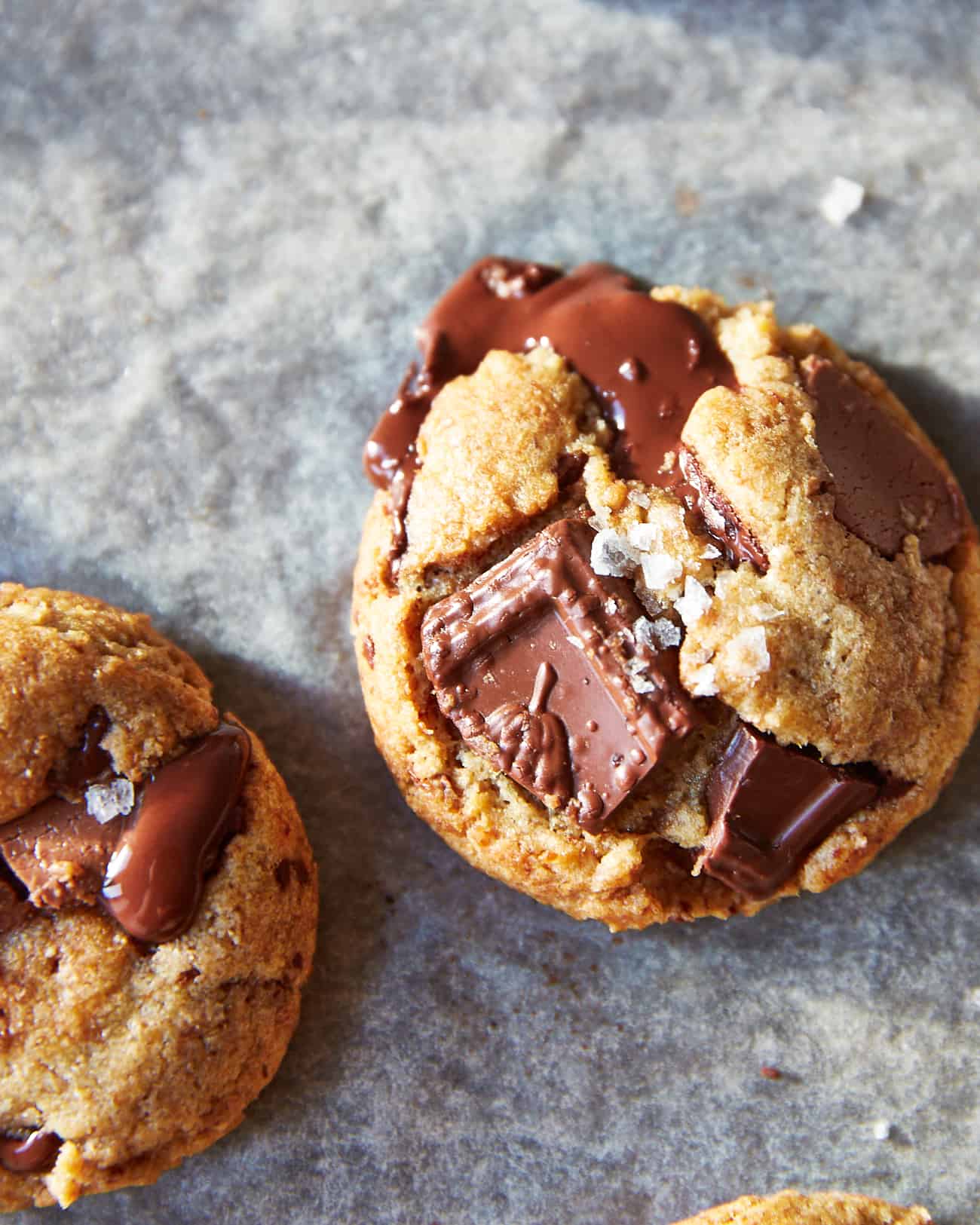 closeup of a vegan chocolate chip cookie with flaky salt