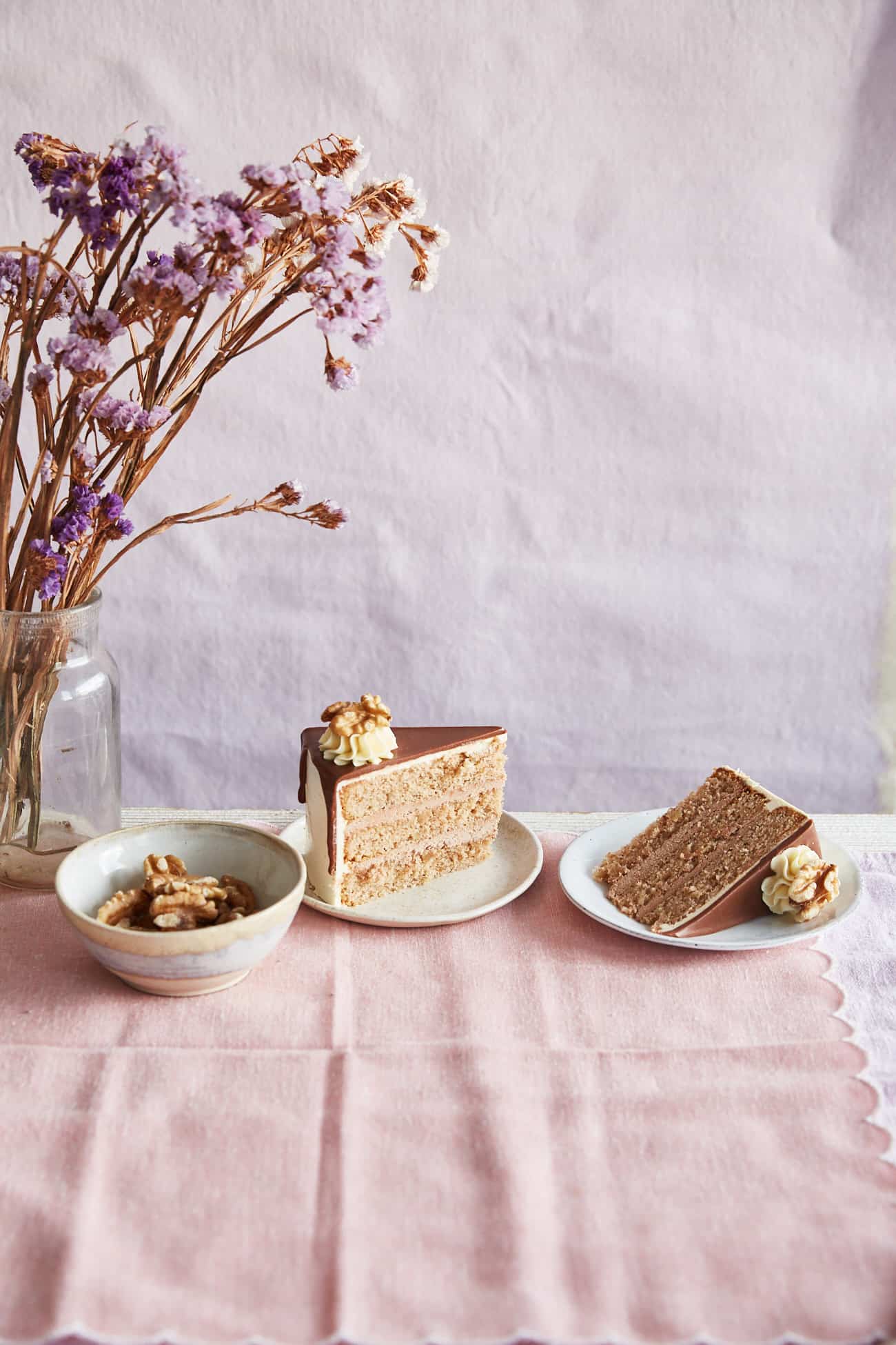 2 slices of walnut whip cake on pink cloth