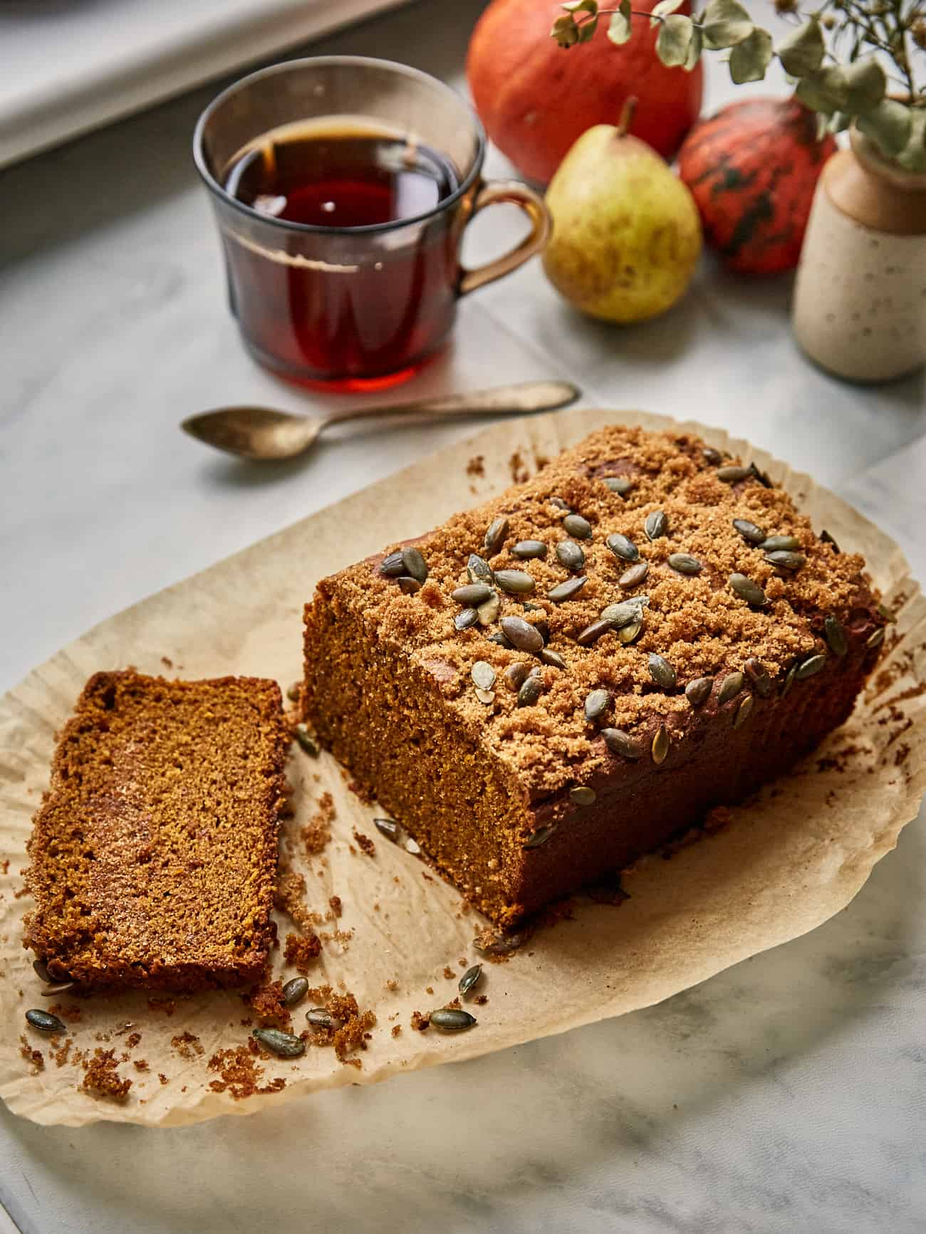 sourdough pumpkin bread sliced with a cup of tea