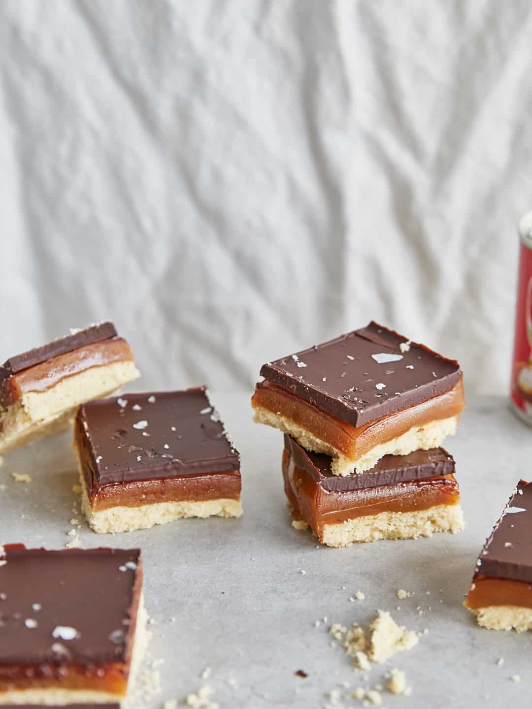 stacked squares of vegan millionaires shortbread made using carnation vegan condensed milk