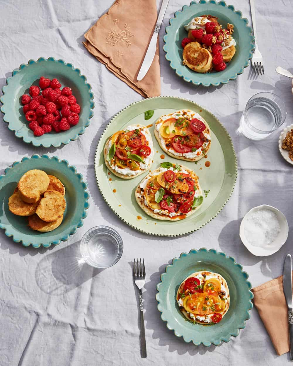 overhead table setting of fig leaf french toast and tomato flatbreads on KCHossack pottery tableware