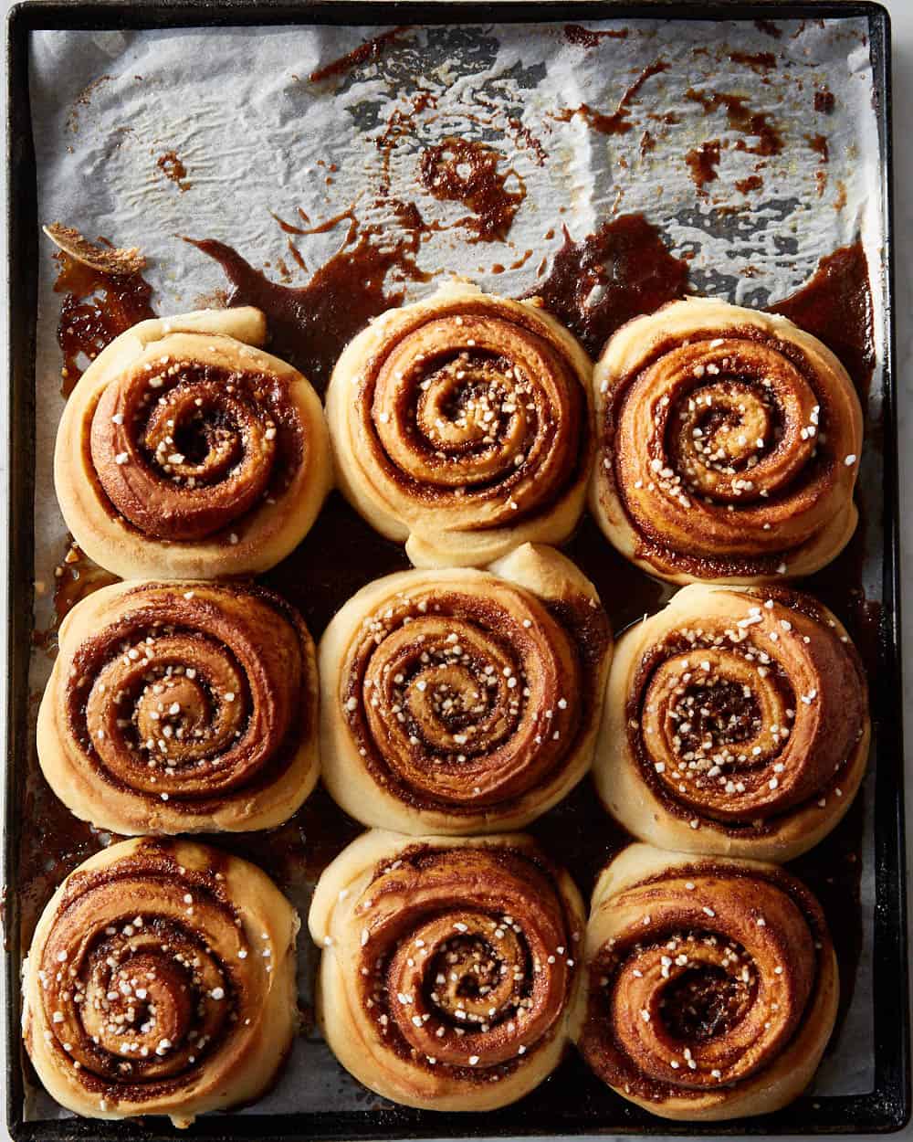 overhead of vegan cinnamon rolls on a baking tray