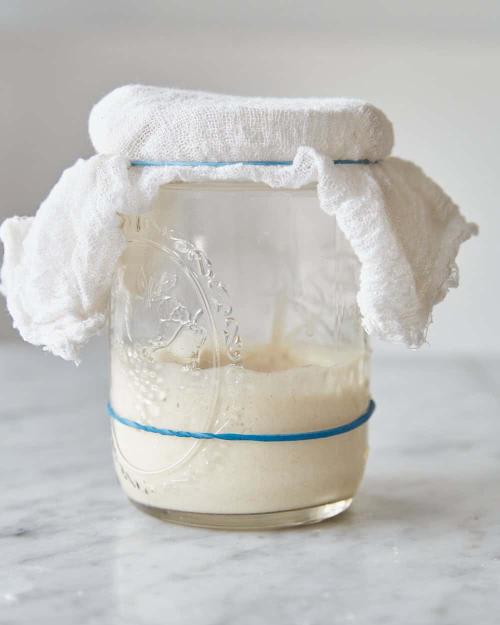 a collapsed sourdough starter in a jar