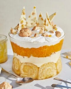 a lemon Swiss roll and amaretti trifle in a glass trifle bowl