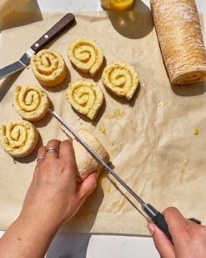 cutting rolled Swiss roll cake for the jubilee pudding