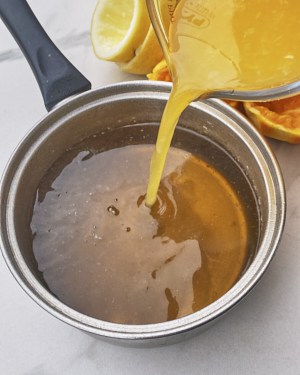 adding orange and lemon juice to jelly mixture