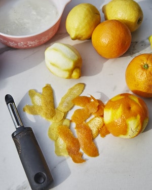 peeling strips of orange and lemon zest