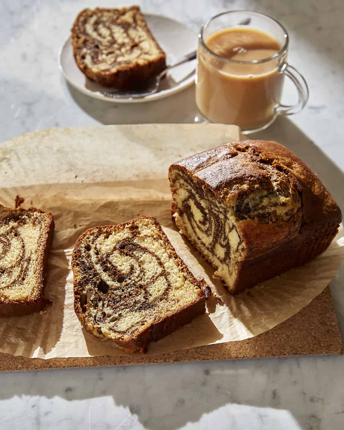 sliced loaf of marbled Vietnamese coffee cake with a mug of tea