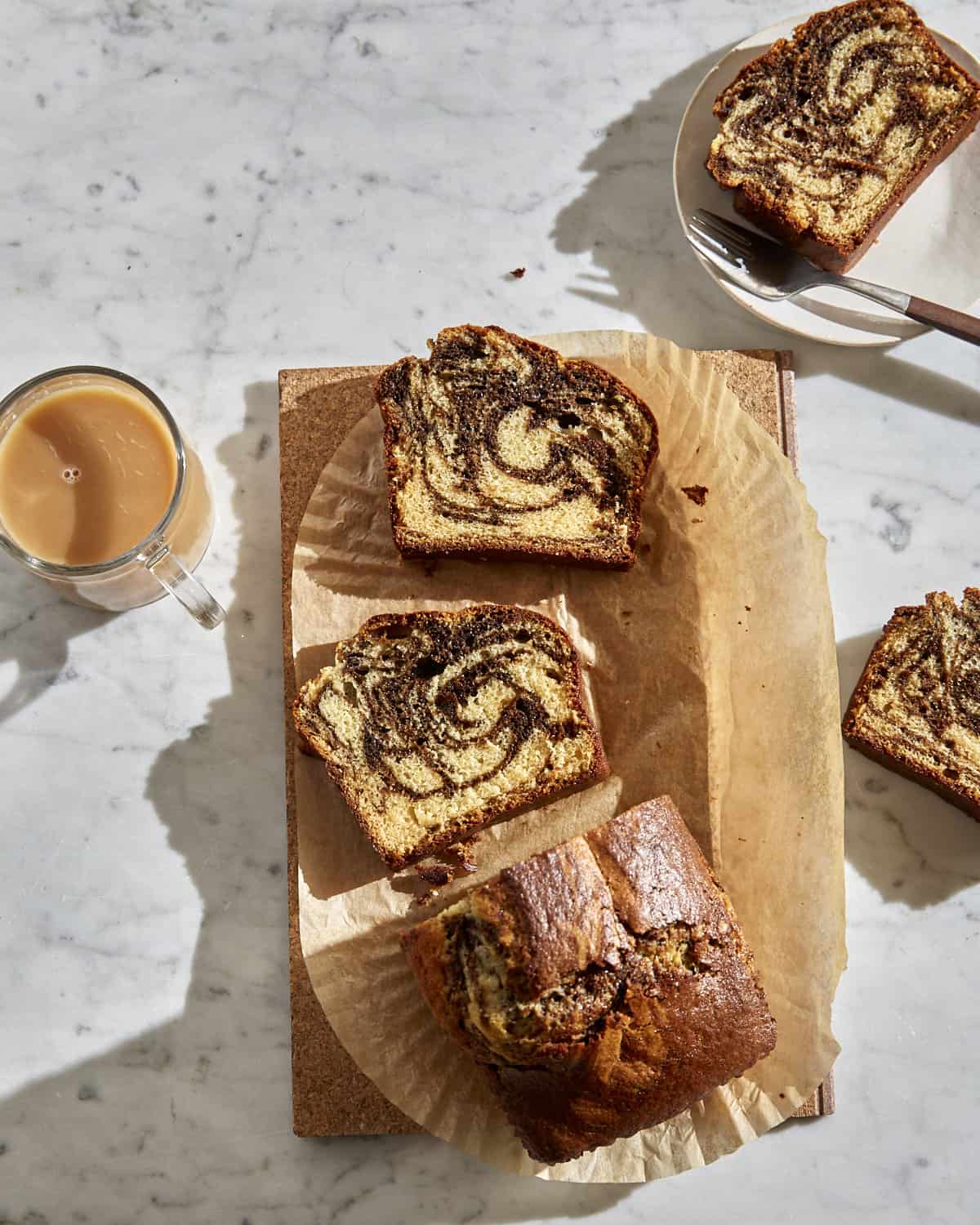 overhead image of marbled Vietnamese coffee cake on a cork trivet with a cup of tea